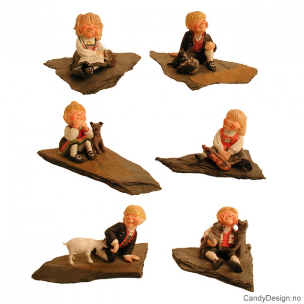 Children in traditional Norwegian costume on rocks